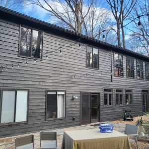 Two stories house with black painted exterior.