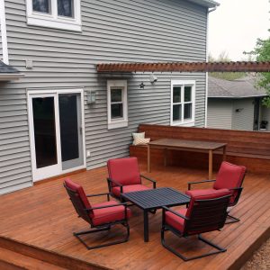 Residential house grey painted walls backyard deck with tables and chairs