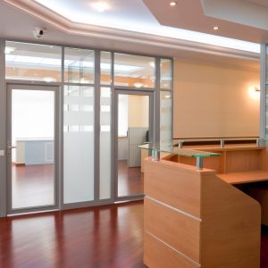 Modern light color painted office interior - reception and working places