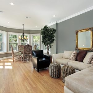 Family room condo in grey and white colored painted walls with rounded table area.