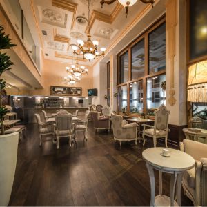 Restaurant light colored painted interior with antique furniture