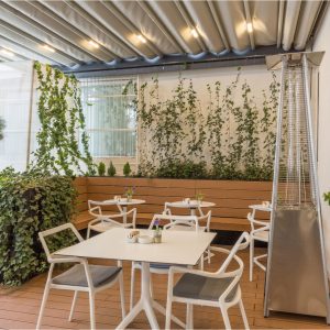Restaurant terrace sitting area with light colored painted walls.